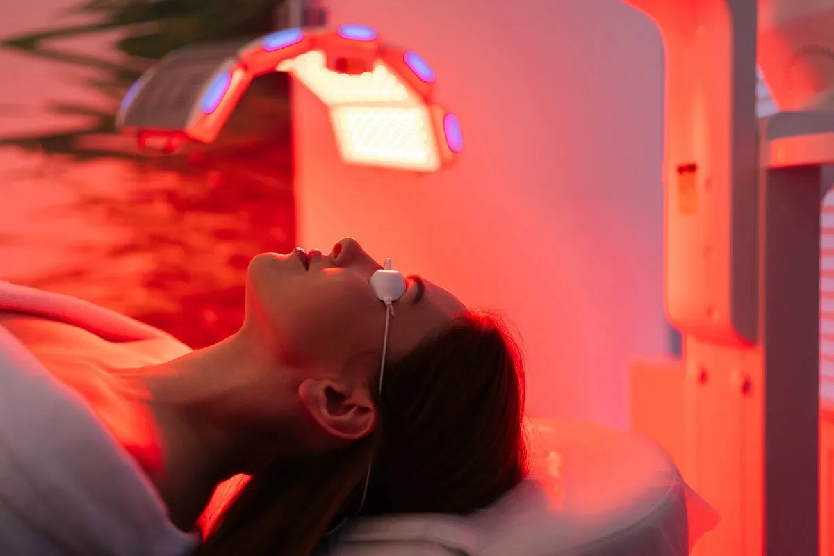 Medical aesthetician performing cavitation on back for body contouring.