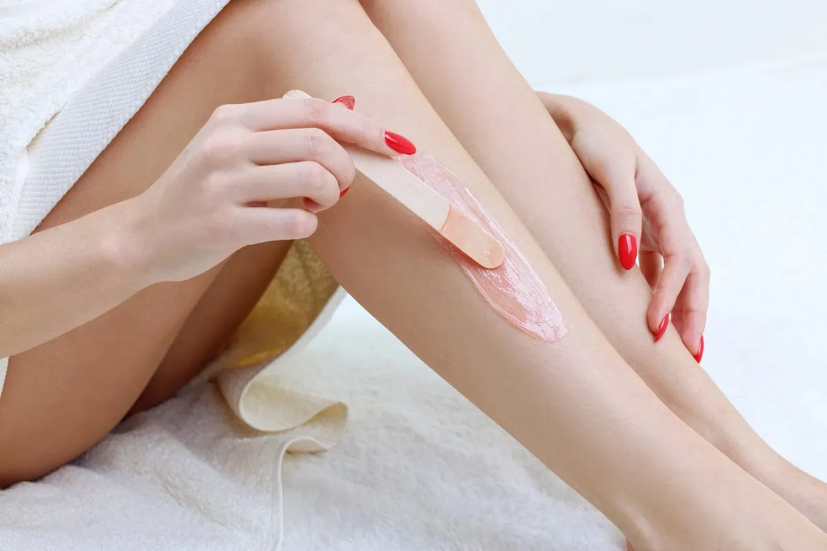 Woman waxing legs in spa setting in Oklahoma City, OK