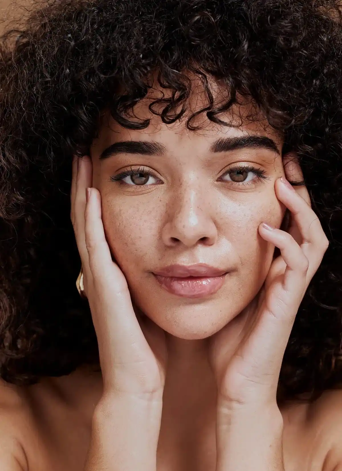 a woman with curly hair and freckles | Beauty Bank+ Membership of Petra's Weightloss Clinic Med Spa in Oklahoma City, OK