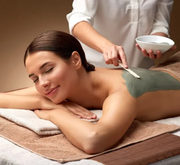 Woman receiving green mud body treatment in Oklahoma City, OK