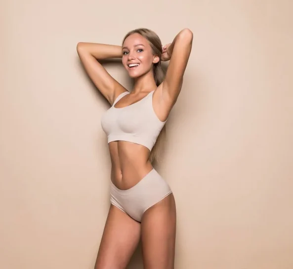 Smiling woman posing in a white outfit in Oklahoma City, OK