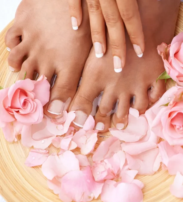 Feet immersed in a warm ion‑foot detox bath with a glowing electrode array.